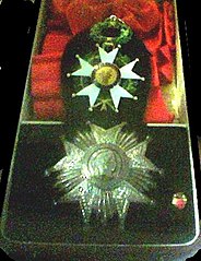 The insignia of a Grand Cross. Nowadays the star of a Grand Cross is gilt. The silver star is the Grand Officer's badge.