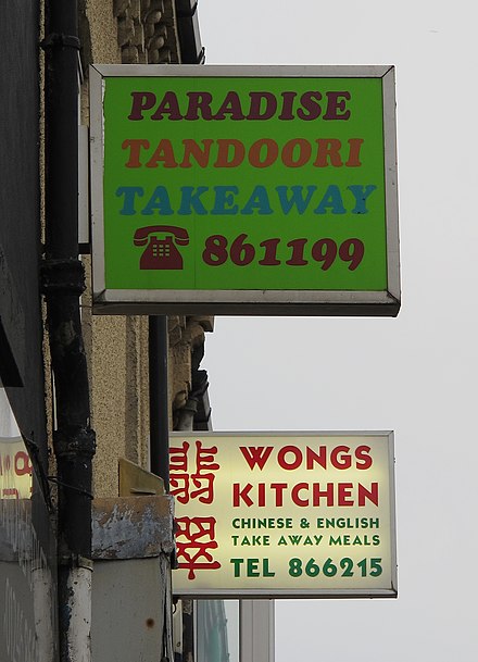 Signs of different takeaway shops in Clay Cross, Derbyshire