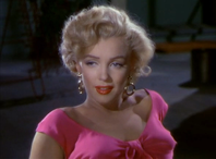 Monroe in Niagara. A close-up of her face and shoulders; she is wearing gold hoop earrings and a shocking pink top
