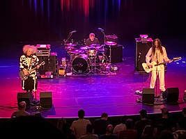 Melvins live in Knoxville, Tennessee, June 2022. Left to right: Buzz Osborne, Dale Crover (behind drum kit) and Steven Shane McDonald.