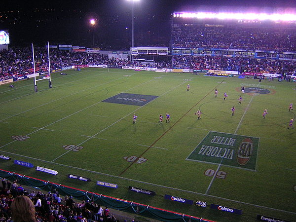 Newcastle International Sports Centre at night showing the old main grandstand