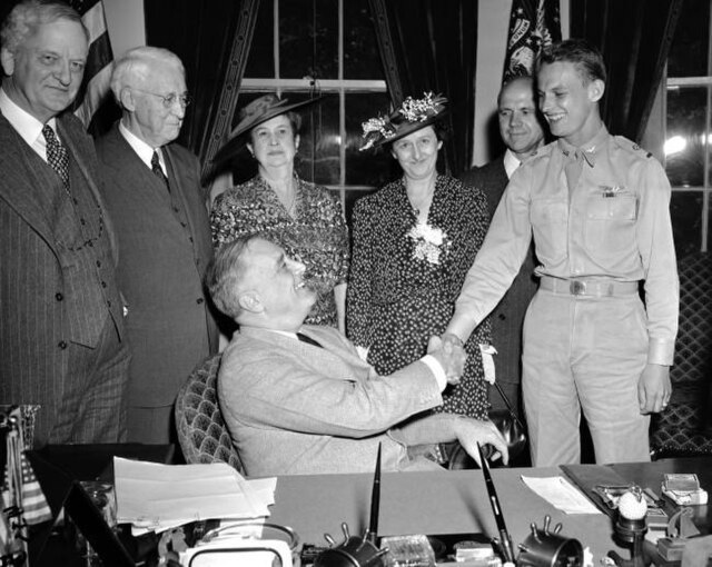 Senator James H. Hughes (D-del.); Mrs. Hughes; Mrs. Julia Welch Schwartz and Mr. George L. Schwartz, Welch's parents; and Lieutenant Welch shaking han