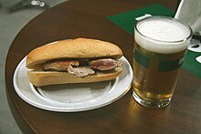 A Spanish pepito prepared with chicken, served with beer Pepito Lomo-Cana.jpg