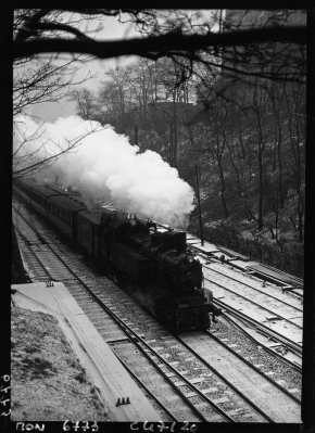 One of the last Petite Ceinture de Paris passenger trains in 1933 - its passenger service would close one year later. View from the Buttes-Chaumont ravine slope to a steam engine and passenger train travelling below the park. Petite ceinture buttes chaumont 1933 jms.png