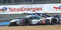 Thumbnail for File:Peugeot 9X8 Hybrid - Loic Duval, Gustavo Menezes &amp; Nico Mueller at Dunlop Chicane at the 2023 Le Mans (53368695323).jpg