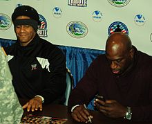 Young and Titus O'Neil signing autographs in December 2013 Prime time players.jpg