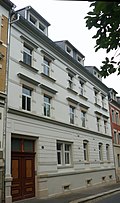 Apartment building with shop in closed development