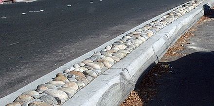 A California arterial road median with decorative cobblestones inset