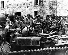 Soldiers of the US 101st Airborne Division with a captured Renault UE in Normandy, June 1944. SC189921-SP.jpg