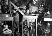 Interior of the hut at Cape Evans with Cherry-Garrard, Bowers, Oates, Meares and Atkinson.