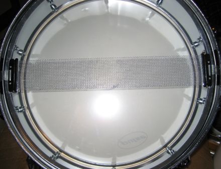 Snares on bottom of a drum