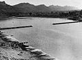 The 1,100 feet (340 m) bridge over the Chindwin, in Burma, nearing completion in 1944. (The sections were constructed on a tributary and floated downstream on pontoons.)