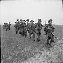 Infantrymen of the 2nd Battalion, Royal Scots Fusiliers advance in single file during operations to outflank German resistance in Uelzen, Germany, 16 April 1945. The British Army in North-west Europe 1944-45 BU3922.jpg