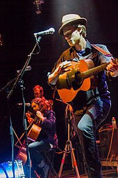 At 9:30 Club in Washington, D.C., on August 2, 2012; touring with Old Crow Medicine Show. Wesley Schultz on acoustic guitar (right), Neyla Pekarek on cello (left). The Lumineers at 930 Club.jpg