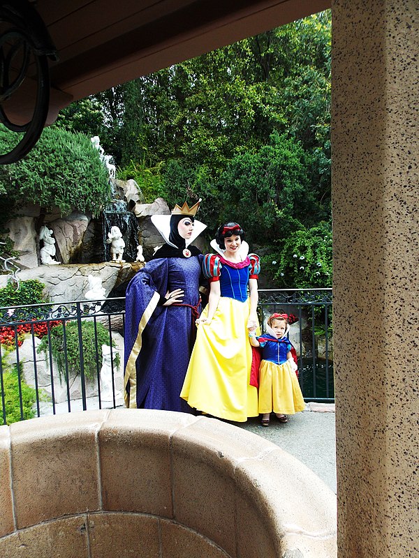 At Disneyland, Snow White and the Evil Queen take a photo with a visitor in 2012.