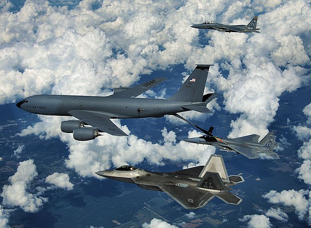 An F-22 Raptor and two F-15 Eagles from Tyndall Air Force Base refuel from a KC-135 Stratotanker of the Mississippi Air National Guard over eastern Fl