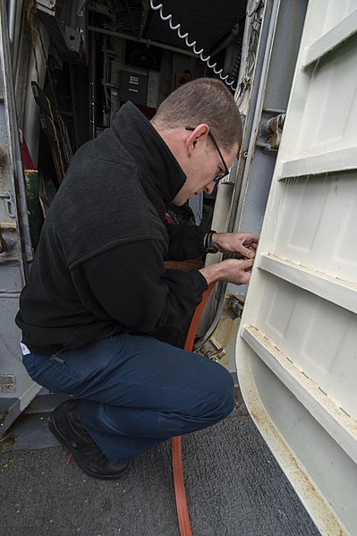 File:U.S. Navy Fire Controlman 2nd Class William Dudley installs a gasket on a watertight door aboard the guided missile destroyer USS Ramage (DDG 61) in the Mediterranean Sea Dec. 12, 2013 131212-N-VC236-014.jpg