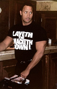 The Rock's popularity was fueled by his charisma and speaking abilities, which led to many catchphrases and merchandising opportunities. WWE - London 6+70500 (22).jpg