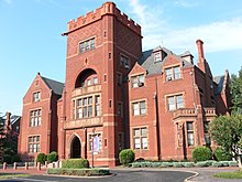 Exterior of red brick building designed in the Tudor Revival Style