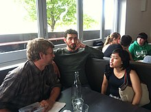 three people sitting at a table