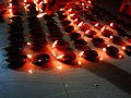 Women lighting earthen lamps on occasion of 2017 Sandhi puja at Manikanchan 29