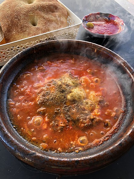Tajine with tomato, meatballs, and egg served boiling hot in Casablanca.