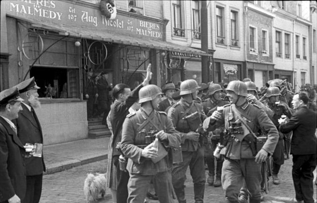 German soldiers welcomed into Malmedy in May 1940 with swastika decoration and Nazi salute