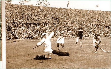 Indian player Dhyan Chand won Olympic gold medals for his team in 1928, 1932 and 1936.[15] Photo shows him scoring a goal against Germany in the 1936 Olympics hockey final.