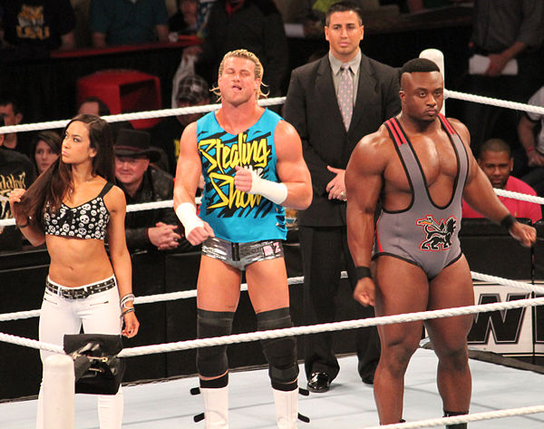 AJ Lee alongside Dolph Ziggler (center) and her bodyguard Big E Langston (right) in February 2013