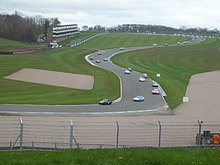 Historic cars race through the Craner Curves towards the Old Hairpin, 2014 Donington Park hill 2014.JPG