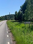 Vägen från Vålberg med den karaktäristiska skorstenen på 90 meter vid tidigare Svenska Rayon AB.