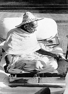 Mahatma Gandhi wearing a Noakhali hat while spinning khadi at Birla House, November 1947.