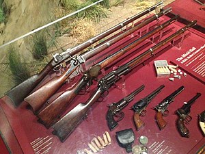 Various repeating guns, revolvers, and rifles of the Civil War in a display case.