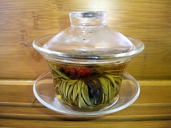 Glass gaiwan, with flowering tea, steeping lidded