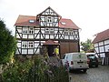 Former harvest house with stable and storage building on one side