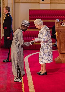 Imrana Alhaji Buba receiving the 2016 Queen's Young Leaders Award from Her Majesty Queen Elizabeth II.jpg