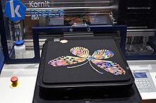 Example of digital textile printing using an Inkjet printer to create a butterfly design on a t-shirt using water-based color ink. Inkjet-decorated T-Shirt (Kornit Breeze).jpg