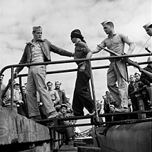 A Japanese POW being led off a US Navy submarine in May 1945. Japanese POW being led off a submarine.jpg