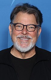 After guest starring in the first-season finale, Jonathan Frakes returned for the second season as his Star Trek: The Next Generation character William Riker. Jonathan Frakes Photo Op Louisville Supercon 2018.jpg