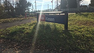 Close-up of sign in front of station platforms