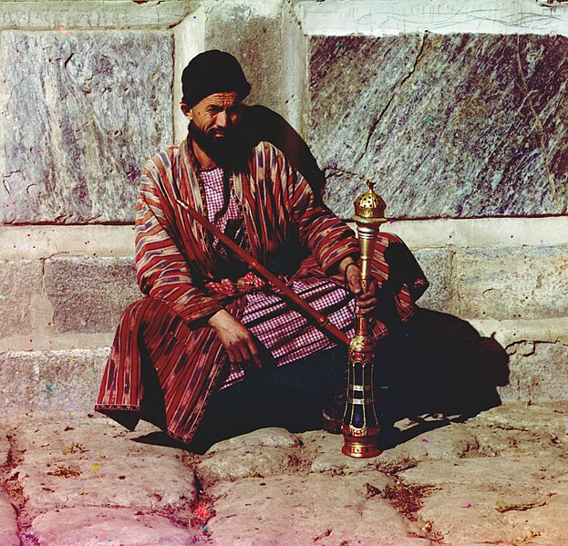 File:Man sitting and holding a hookah.jpg