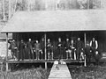 Men posing with fishing tackle on porch, Cascade Mountains, January 1, 1887 (WASTATE 2421).jpeg