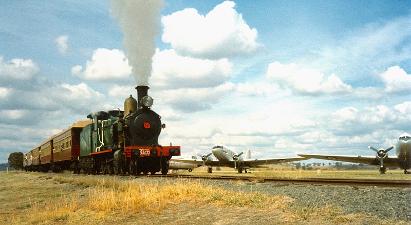 File:NSWGR loco 3026 with ARHS train passes through RAAF Base Wagga with aircraft in background, 1983 (closer).jpg
