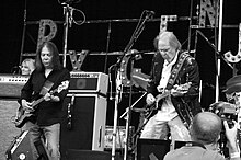 Rick Rosas (left) performing with Neil Young in 2008.