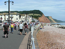Sidmouth seafront; the red cliff is Salcombe Hill exposing Jurassic rocks Sidmouth seafront devon arp.jpg