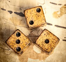 The game of passe-dix is played with three dice Three Antique Dice.jpg