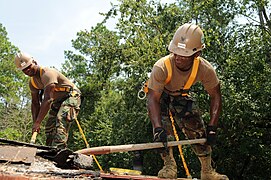 US Navy 110825-N-UH337-043 Construction Electrician 2nd Class Johnny Hawkins and Builder 2nd Class Raymond A. Rankins, both assigned to Naval Mobile.jpg