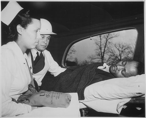 "After receiving first aid treatment in practice raid in Washington, DC, air-raid `victim' is removed to hospital by a M - NARA - 535826