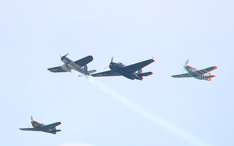File:'Missing Man' F4U exiting formation of TBM, P-40, and P-51 (all Texas Flying Legends Museum) (17498769821).jpg