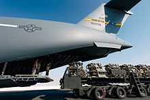 Airmen assigned to the 8th Expeditionary Air Mobility Squadron prepare to load a cargo onto an C-17 on 27 October as part of the U.S.-led airstrikes supporting the Mosul offensive, Al Udeid Air Base, Qatar Airmen load cargo onto an 816th Expeditionary Airlift Squadron C-17 Globemaster III.jpg